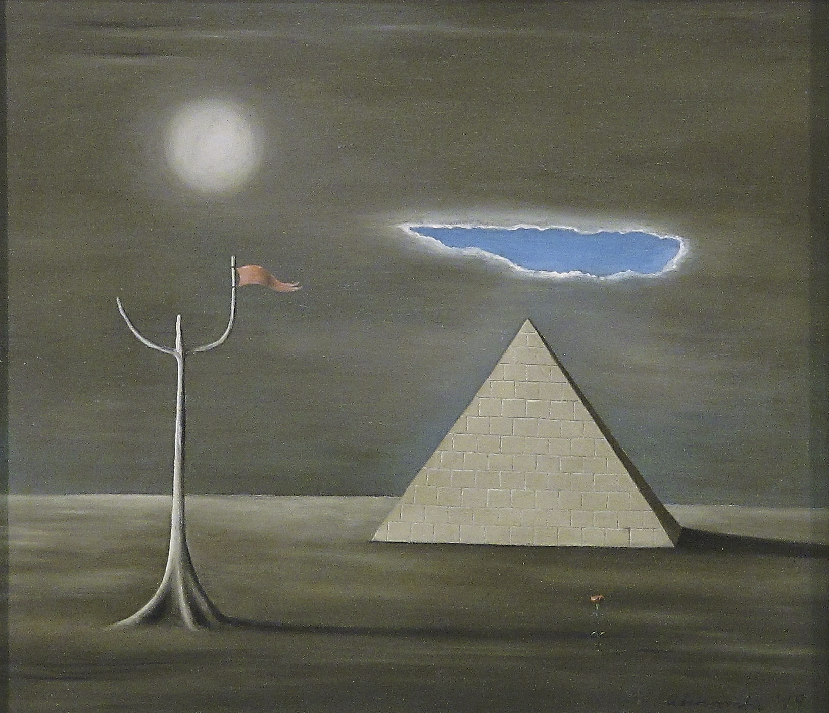 A painting by Gertrude Abercrombie showing a desolate barren landscape. On the left is a skeletal tree with a small pink flag attached to one of 2 branches. Above it is a full moon. A dark cloudy sky is rent by a patch of blue sky opening up just above a pyramid.